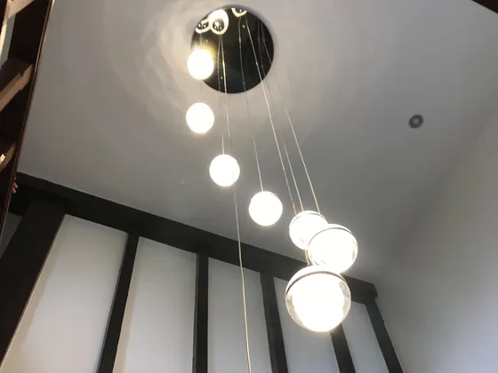 Cluster of glass globe pendants hanging down a stairwell